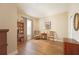 Cozy living room with wood floors, a bookshelf, and comfortable seating, ideal for relaxing or reading at 5020 Savona Run, Bradenton, FL 34211