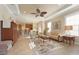 The open concept features a ceiling fan, tile floors, and easy access to the kitchen and patio at 5020 Savona Run, Bradenton, FL 34211