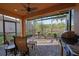 Screened patio features ample seating, a ceiling fan, and an outdoor kitchen area at 5020 Savona Run, Bradenton, FL 34211