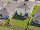 An aerial view of a home showcasing a spacious backyard with a well-maintained lawn and fence at 5132 Rocky Coast Pl, Palmetto, FL 34221