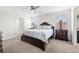 Main bedroom featuring a large bed with lamps on either side at 5132 Rocky Coast Pl, Palmetto, FL 34221