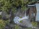 Aerial view of backyard featuring a firepit seating area and deck with outdoor furniture at 5250 Calle De Rio, Sarasota, FL 34242