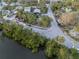 Aerial view of a neighborhood surrounded by lush greenery and trees at 5250 Calle De Rio, Sarasota, FL 34242