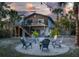 Relaxing backyard boasts a firepit area with Adirondack chairs, creating a perfect spot for cozy evenings at 5250 Calle De Rio, Sarasota, FL 34242