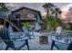Inviting backyard featuring a firepit with Adirondack chairs, perfect for outdoor gatherings and relaxation at 5250 Calle De Rio, Sarasota, FL 34242