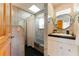 Bright bathroom featuring tiled walls, shower/tub combo, and vanity with round mirrors at 5250 Calle De Rio, Sarasota, FL 34242