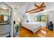 Bedroom featuring a vaulted ceiling with exposed wood beams, and ensuite bathroom at 5250 Calle De Rio, Sarasota, FL 34242