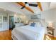 Spacious bedroom featuring exposed wood beams, ensuite bathroom, and hardwood flooring at 5250 Calle De Rio, Sarasota, FL 34242