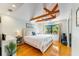 Bedroom with vaulted ceiling, exposed wood beams, and a large window with a view at 5250 Calle De Rio, Sarasota, FL 34242