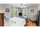 Bright bedroom featuring terracotta flooring, a ceiling fan, and two windows with natural light at 5250 Calle De Rio, Sarasota, FL 34242