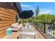 Inviting deck features outdoor seating with a fire pit, lush greenery, and a large umbrella at 5250 Calle De Rio, Sarasota, FL 34242