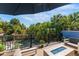Relaxing deck area with a firepit and views of the lush tropical surroundings at 5250 Calle De Rio, Sarasota, FL 34242