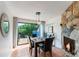 Dining room with fireplace and sliding glass doors offering scenic views at 5250 Calle De Rio, Sarasota, FL 34242
