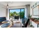 Well-lit dining area with a view of the lush greenery from the outdoor deck at 5250 Calle De Rio, Sarasota, FL 34242