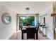Dining room featuring a modern pendant light and sliding glass doors to the balcony at 5250 Calle De Rio, Sarasota, FL 34242