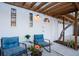 Cozy porch with seating, pergola, and white door provides a welcoming entrance at 5250 Calle De Rio, Sarasota, FL 34242