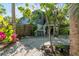 Charming home with white gravel yard and lush landscaping provides a tranquil setting at 5250 Calle De Rio, Sarasota, FL 34242