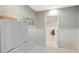 Hallway with a mini fridge leading to living room with Terrazzo floors and stylish decor at 5250 Calle De Rio, Sarasota, FL 34242