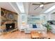 Cozy living room with a stone fireplace, skylights, and comfortable seating at 5250 Calle De Rio, Sarasota, FL 34242