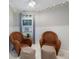Cozy sitting area featuring two wicker chairs, natural light, and decorative string lights at 5250 Calle De Rio, Sarasota, FL 34242