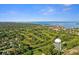 An aerial view features the golf course and waterfront near homes in this community at 625 Duchess Blvd, Dunedin, FL 34698