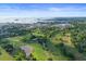 Expansive aerial view showcasing the golf course, community and ocean at 625 Duchess Blvd, Dunedin, FL 34698