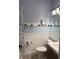 Cozy bathroom with stylish fixtures, a shower, and decor with a beachy coastal theme at 625 Duchess Blvd, Dunedin, FL 34698