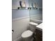 Close-up of a well-maintained bathroom with white toilet, grey vanity, and decorative accents at 625 Duchess Blvd, Dunedin, FL 34698
