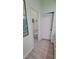 Bathroom area with toilet and linen closet visible from the neutral painted hallway at 625 Duchess Blvd, Dunedin, FL 34698