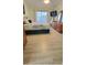 Bright bedroom with a queen bed, a ceiling fan, and wood-look laminate flooring at 625 Duchess Blvd, Dunedin, FL 34698