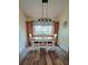 Dining room with modern light fixture, large window, and built-in cabinets at 625 Duchess Blvd, Dunedin, FL 34698