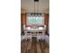 Dining room features a modern light fixture, window, and built-in cabinets at 625 Duchess Blvd, Dunedin, FL 34698
