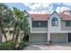 Inviting two-story townhome with attached garage and mature landscaping at 625 Duchess Blvd, Dunedin, FL 34698