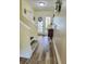 Foyer with wood-look floors, staircase, and neutral paint at 625 Duchess Blvd, Dunedin, FL 34698