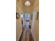 Bright hallway features clean neutral paint, artwork, wood-look floors and access to other rooms at 625 Duchess Blvd, Dunedin, FL 34698