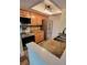 Updated kitchen features stainless appliances, wood cabinets, and granite countertops at 625 Duchess Blvd, Dunedin, FL 34698