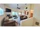Open-concept living room featuring a fireplace, ceiling fan, and a sliding door to a balcony at 625 Duchess Blvd, Dunedin, FL 34698