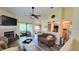 Bright living room with fireplace, ceiling fan, and access to outdoor space at 625 Duchess Blvd, Dunedin, FL 34698