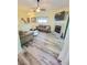 Open-concept living room with fireplace and wood-look floors at 625 Duchess Blvd, Dunedin, FL 34698