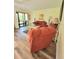 Bright living room with comfortable seating, sliding glass doors, and wood-look floors at 625 Duchess Blvd, Dunedin, FL 34698