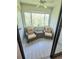 Cozy patio seating area showcasing two chairs, a small table, and beautiful views at 625 Duchess Blvd, Dunedin, FL 34698