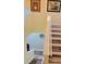 Wooden staircase with white railing and decorative wall art at 625 Duchess Blvd, Dunedin, FL 34698