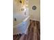 Stairway with modern flooring, white railing and walls with decorative accents and stylish lighting at 625 Duchess Blvd, Dunedin, FL 34698