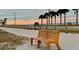 Scenic waterfront walking path with a memorial bench overlooking the beach at 625 Duchess Blvd, Dunedin, FL 34698