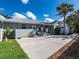Spacious concrete backyard with lawn, partial fence and landscaping at 721 Cadiz Rd, Venice, FL 34285