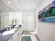 Bathroom with double vanity, blue counters, and a large decorative painting at 721 Cadiz Rd, Venice, FL 34285