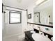 Well-lit bathroom with tile floor, shower with black trim, and stylish vanity with sink at 721 Cadiz Rd, Venice, FL 34285