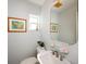 Powder room featuring a floating sink, modern faucet, and stylish artwork at 721 Cadiz Rd, Venice, FL 34285