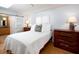Comfortable bedroom featuring a queen bed, white linens, and natural light from a window at 721 Cadiz Rd, Venice, FL 34285