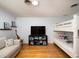 Cozy bedroom with bunk beds, a comfortable sofa, and a mounted television for entertainment at 721 Cadiz Rd, Venice, FL 34285